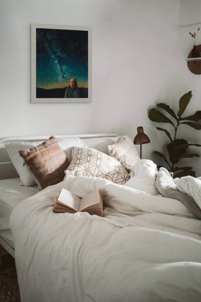 Framed print of Pondering God's Promise styled above a bed