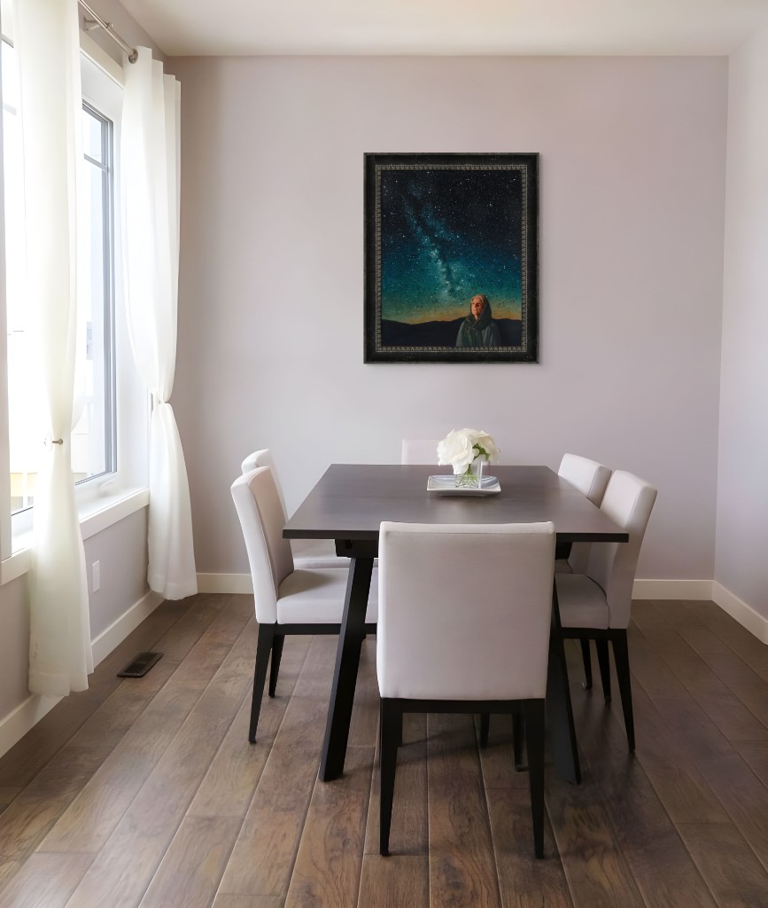 Ornately framed print in a bright, minimalist dining room