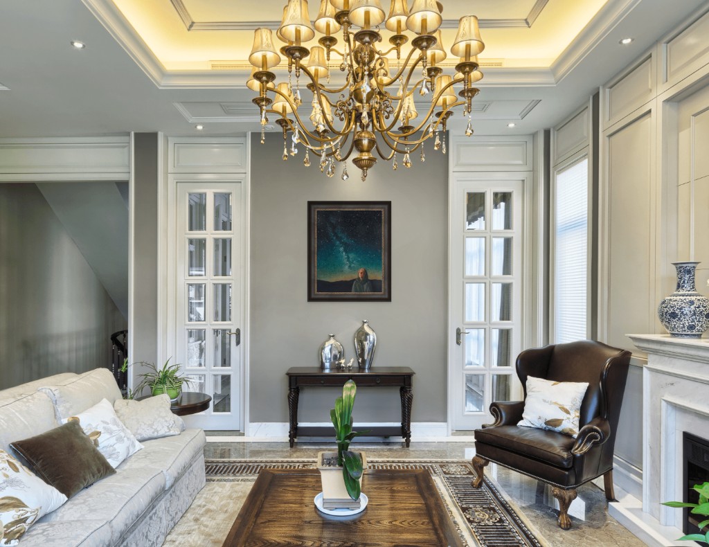 Print in a formal living room with a crystal chandelier